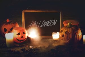 halloween sign with pumpkin and candles