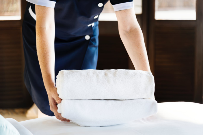 a person preparing white towels